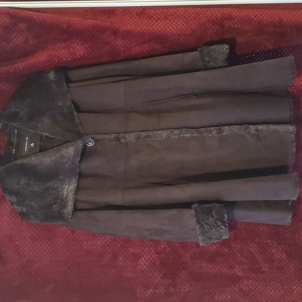 Light weight faux fur and suede coat. Coat is lined and sleeves are adjustable.